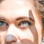 A close up of a woman with a nose piercing.