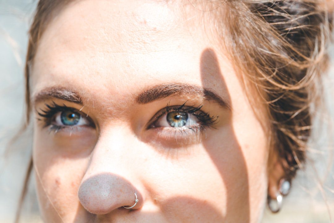 A close up of a woman with a nose piercing.